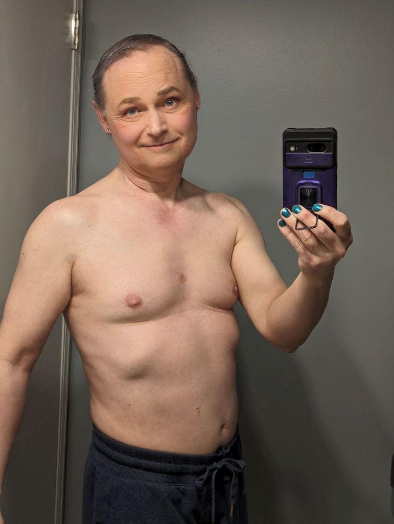 A topless mirror selfie I took last week. I'm in very similar shape to the 2017 pic, but now I have no body hair--and no farmer tan!
